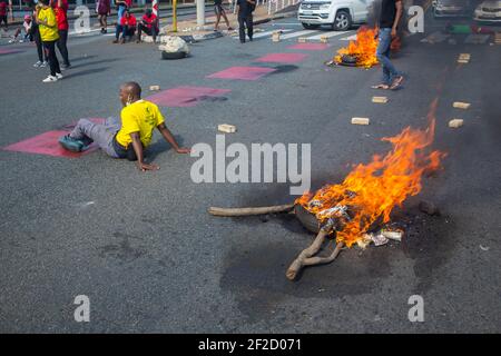 Students block traffic during the demonstration.South African police moved to disperse students protesting against refusal by Wits University to register those students in arrears with tuition fees. Police Clashed with protesters who were blocking the roads with rubble and disrupting traffic in Johannesburg. Stock Photo