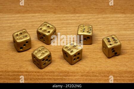 A set of six gambling dice on the table. The dice rolled shows sixes. Stock Photo