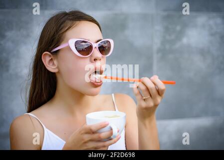 Young woman enjoy sipping drink through straw. Pretty woman sip beverage with drinking straw. Cute woman drink through straw in cafe. Taste the Stock Photo
