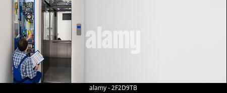 Maintenance Electrician Worker Repairing Elevator. Repair Services Stock Photo