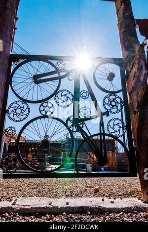 Custom gate of bicycle parts in the fence of The 146 Taphouse;  Salida; Colorado; USA Stock Photo