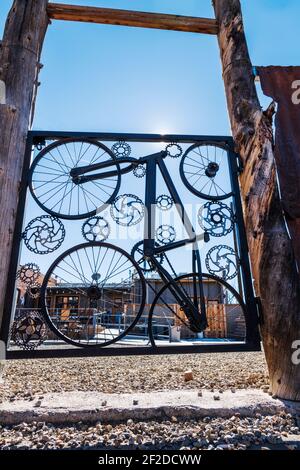 Custom gate of bicycle parts in the fence of The 146 Taphouse;  Salida; Colorado; USA Stock Photo