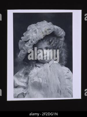 Portrait of little girl in frilly hat Stock Photo