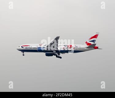 london, Heathrow Airport - April 2019: British Airways, Boeing 777 flying through an overcast London Sky. Image Abdul Quraishi
