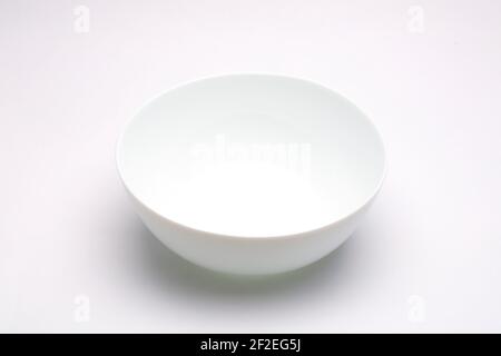 White bowl ,empty white bowl arranged on white textured background. Stock Photo