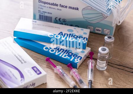 Prague, Czech Republic, March 11, 2021. Antigen test vaccine syringes and protective masks equipment for testing and prevention of Coronavirus Covid-1 Stock Photo