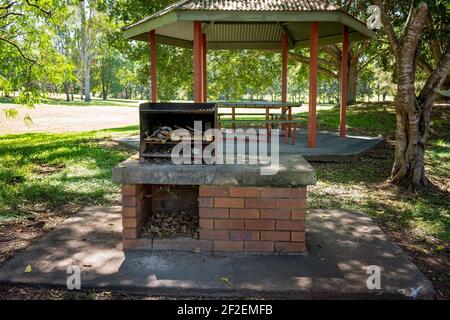 A wood burning barbecue with picnic shelter in a public outdoor park Stock Photo