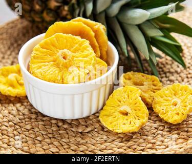 Pineapple dried rings on a rustic background Stock Photo