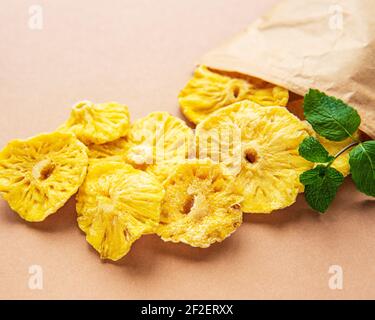 Pineapple dried rings on a brown background Stock Photo