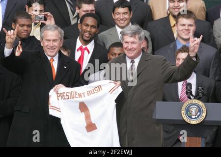President George W. Bush Holds up a University of Texas Longhorns Jersey with Head Football Coach Mack Brown. Stock Photo