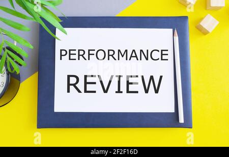 Word writing text Performance Review. Business Concept to identifies strengths and weaknesses, offers feedback, and sets goals for future performance Stock Photo