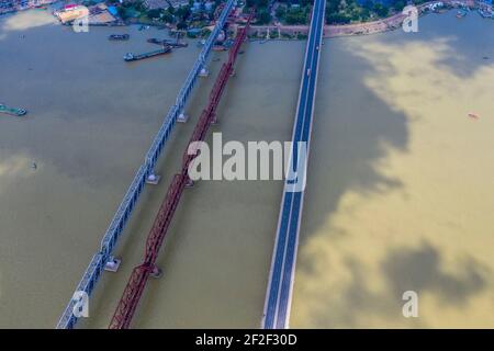 Aerial photo of Syed Nazrul Islam Bridge and two rail way bridges cross the Meghna River from Bhairab Bazar to Ashuganj. Bangladesh. Stock Photo