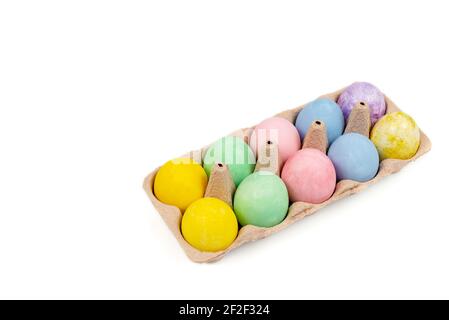 Natural dye Easter eggs in carton tray isolated on a white background. Copy space, top view Stock Photo