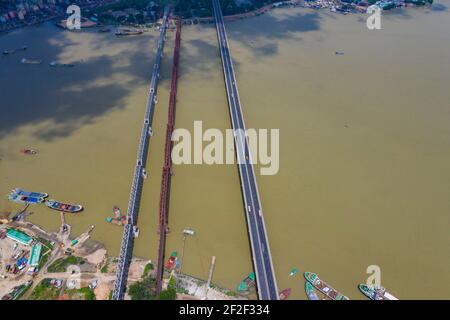 Aerial photo of Syed Nazrul Islam Bridge and two rail way bridges cross the Meghna River from Bhairab Bazar to Ashuganj. Bangladesh. Stock Photo