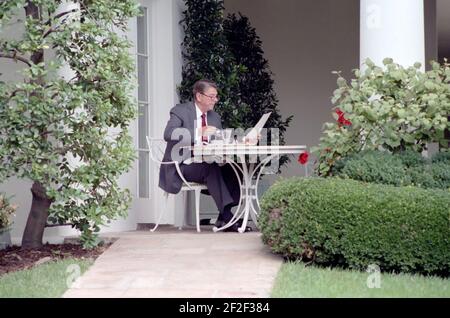 President Ronald Reagan reading with glasses on and eating lunch. Stock Photo