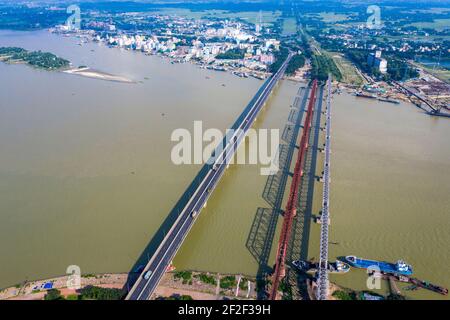 Aerial photo of Syed Nazrul Islam Bridge and two rail way bridges cross the Meghna River from Bhairab Bazar to Ashuganj. Bangladesh. Stock Photo