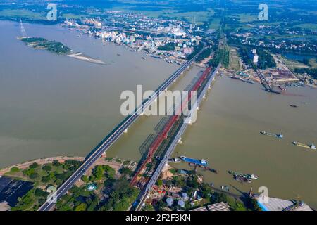 Aerial photo of Syed Nazrul Islam Bridge and two rail way bridges cross the Meghna River from Bhairab Bazar to Ashuganj. Bangladesh. Stock Photo