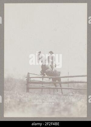 President Theodore Roosevelt on horseback jumping over rail Stock Photo