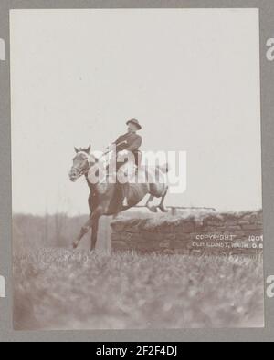 President Theodore Roosevelt on horseback jumping over wall Stock Photo