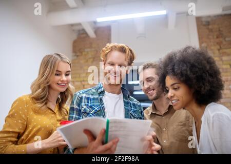 Group of young professionals working on the project together Stock Photo