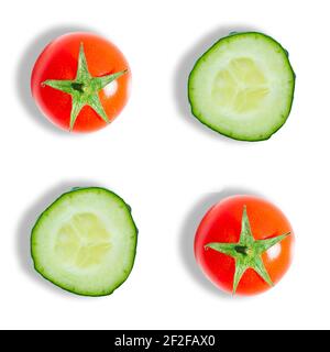 Top view of fresh cucumber slices and red cherry tomatoes isolated on white background. Flat lay composition. Fresh vegetables Stock Photo