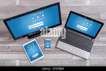 Online tax service concept shown on different information technology devices Stock Photo
