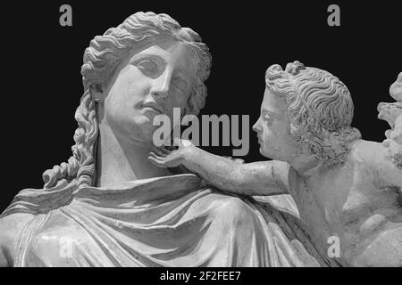Antique statue of Eirene with the infant Ploutos isolated on white