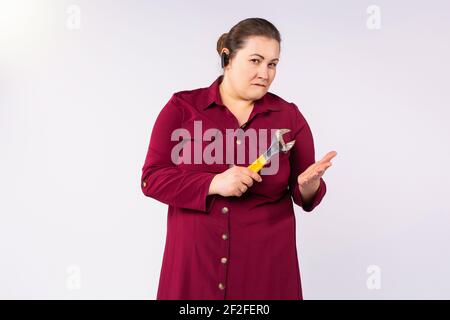 Large size portrait of female engineer. Focused looking at the camera. Gray background with empty space. Stock Photo