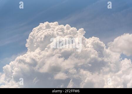 Cumulonimbus cloud formation. Blue sky and rain clouds. Storm-forming cloud. Climatology and atrmosphere. Thermal inversion. Stock Photo