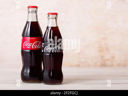 LONDON, UK - AUGUST 03, 2018: Glass bottles of Original Coca Cola soft drink on wood. Most popular drink in the world. Stock Photo