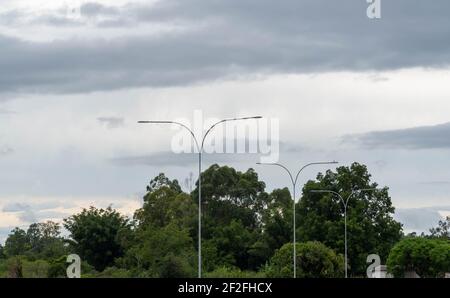 Public streetlights. Lighting infrastructure on public roads. Technology and infrastructure of electrical networks. Stock Photo