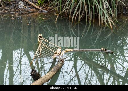 Shopping trolley or cart dumped in a river, UK Stock Photo