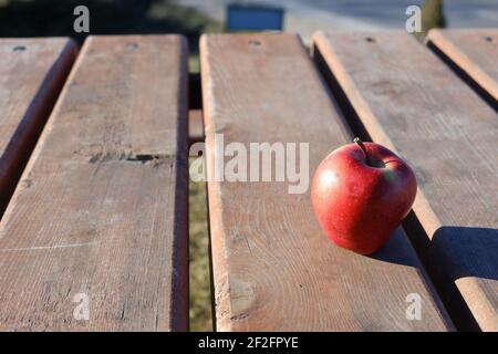 Red apple on wooden table outdoor Stock Photo