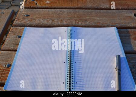 Open notebook and Lamy Fountain Pen Outdoor on Wooden Desk Stock Photo
