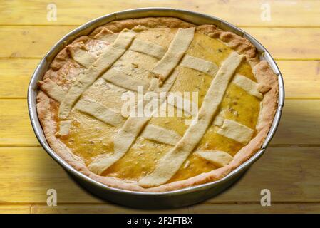 Easter cake, called napolitan pastiera, traditional homemade dessert in baking tray on rustic wooden table Stock Photo
