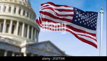 American flag waving with the US Capitol Hill in the background Stock ...
