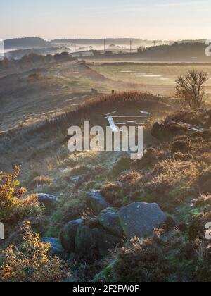 The view along Otley Chevin captured from Surprise View on a beautiful misty morning in late autumn with Jennys Cottage prominient in the frame. Stock Photo