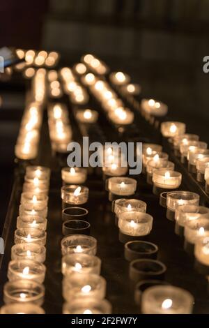 burning sacrificial candles in a church Stock Photo