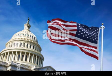 American flag waving with the US Capitol Hill in the background Stock Photo