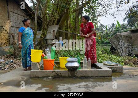 Kolkata, India. 12th Mar, 2021. Women are collecting drinking water from a tube well in a Dhopakhali area outskirt Kolkata. (Photo by Sudipta Das/Pacific Press) Credit: Pacific Press Media Production Corp./Alamy Live News Stock Photo