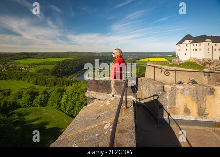 Side view of a Senior Woman with a Red Jacket at Königstein, Fortress, Elbe Valley, Saxon Switzerland, Germany Stock Photo
