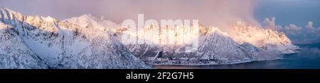 Panorama of snow mountain range with sunshine in the morning at Senja Island, Northern Norway Stock Photo