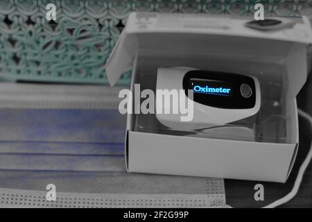a closeup for a fingertip pulse oximeter that measures the oxygen saturation of the blood and the pulse rate for Covid-19 pandemic . Stock Photo