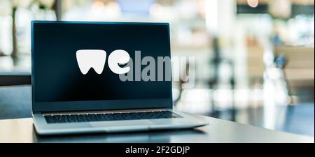 POZNAN, POL - FEB 6, 2021: Laptop computer displaying logo of WeTransfer, an internet-based computer file transfer service based in the Netherlands, f Stock Photo