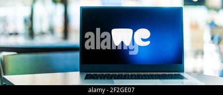 POZNAN, POL - FEB 6, 2021: Laptop computer displaying logo of WeTransfer, an internet-based computer file transfer service based in the Netherlands, f Stock Photo