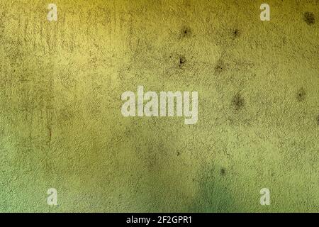 Worn out green outdoors wall with grunge texture and darker stains. Stock Photo