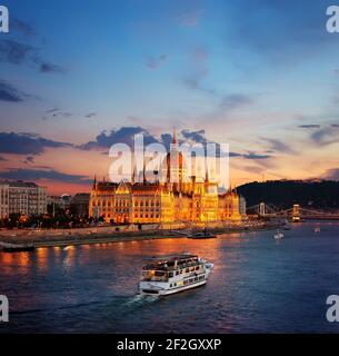 Illuminated Hungarian Parliament and famous bridges in Budapest Stock Photo