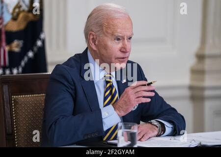 US President Joe Biden meets virtually with his counterparts in the âÂ€Â˜Quad,âÂ€Â™ Prime Minister Narendra Modi of India, Prime Minister Scott Morrison of Australia, and Prime Minister Yoshihide Suga of Japan, from the State Dining Room of the White House in Washington DC, USA, 12 March 2021. Stock Photo