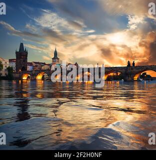 Fiery sunset over Charles bridge on river Vltava in Prague Stock Photo