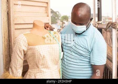 a tailor doing measurement Stock Photo